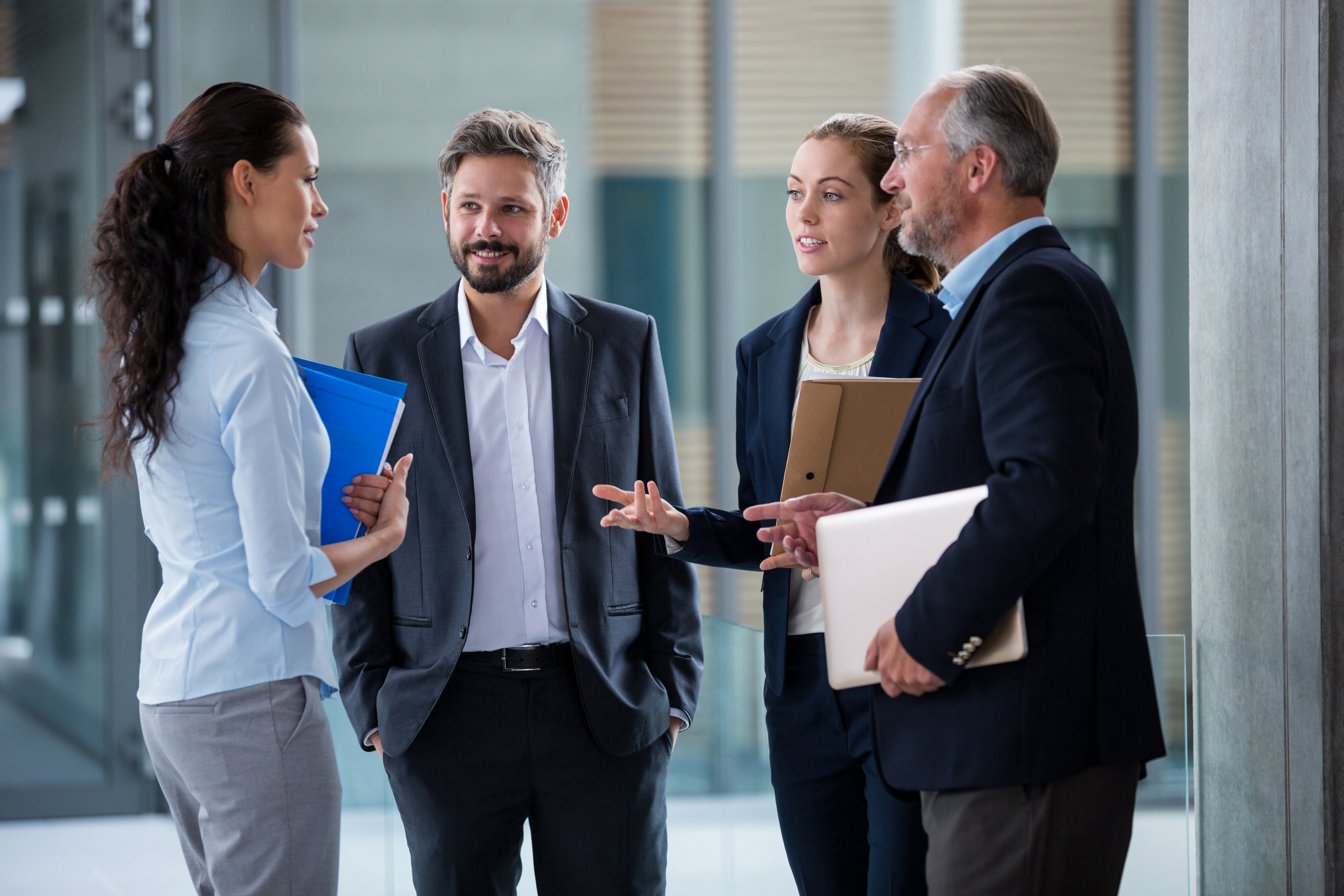 Businesspeople having a discussion in office corridor
